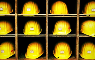 hardhats sitting in cubbies.