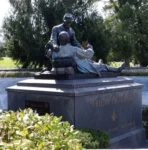 The Friend to Friend monument in Gettysburg, featuring a sculpture of Northern and Southern Civil War soldiers, one of whom is laying down and the other is kneeling to talk to him.
