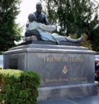 The Friend to Friend monument in Gettysburg, featuring a sculpture of Northern and Southern Civil War soldiers, one of whom is laying down and the other is kneeling to talk to him.