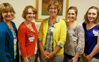 Masonic Village music therapists standing together indoors.