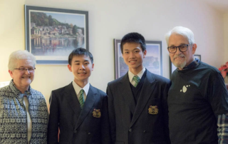 Smiling couple with two smiling exchange students.