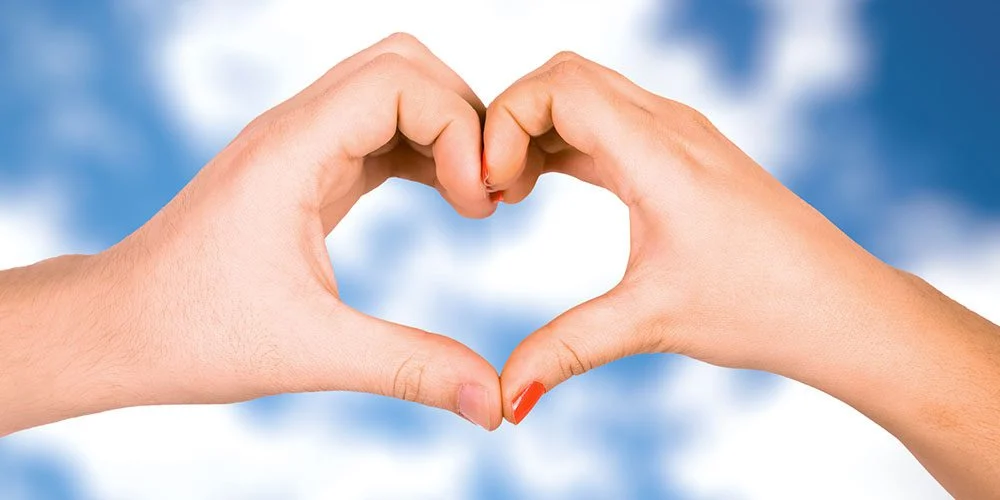 Two hands cupped together in a heart shape.