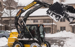 Piece of equipment clearing snow from a driveway at Masonic Village.