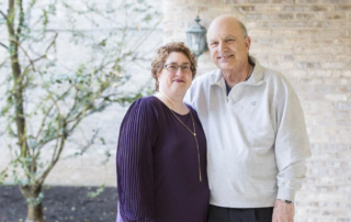 Daughter and son of Carol Meridionale, a Masonic Village Hospice patient, standing together outdoors.
