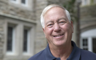 Bill Mowbray, a smiling senior man with short hair.