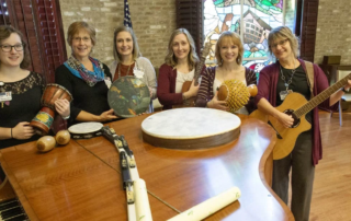 Masonic Village's Music Therapy team holding up a variety of instruments.