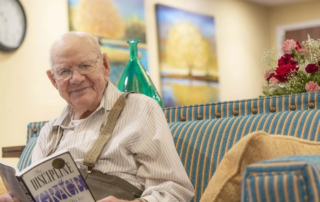 Smiling senior man reading a book.