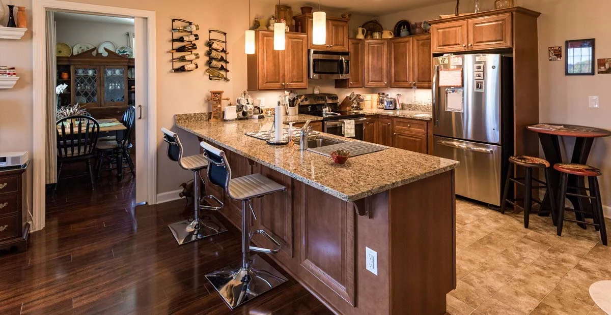 Large kitchen with wooden cabinets in Lafayette Hill apartment.