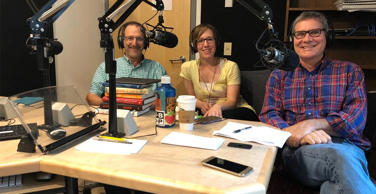 Hosts of the Democracy Works podcast seated in a studio.