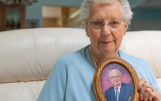 Widow holding spouse's photo