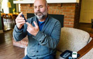 Man Testing Blood Glucose