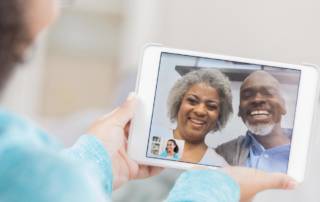 An older couple video chat with a tablet