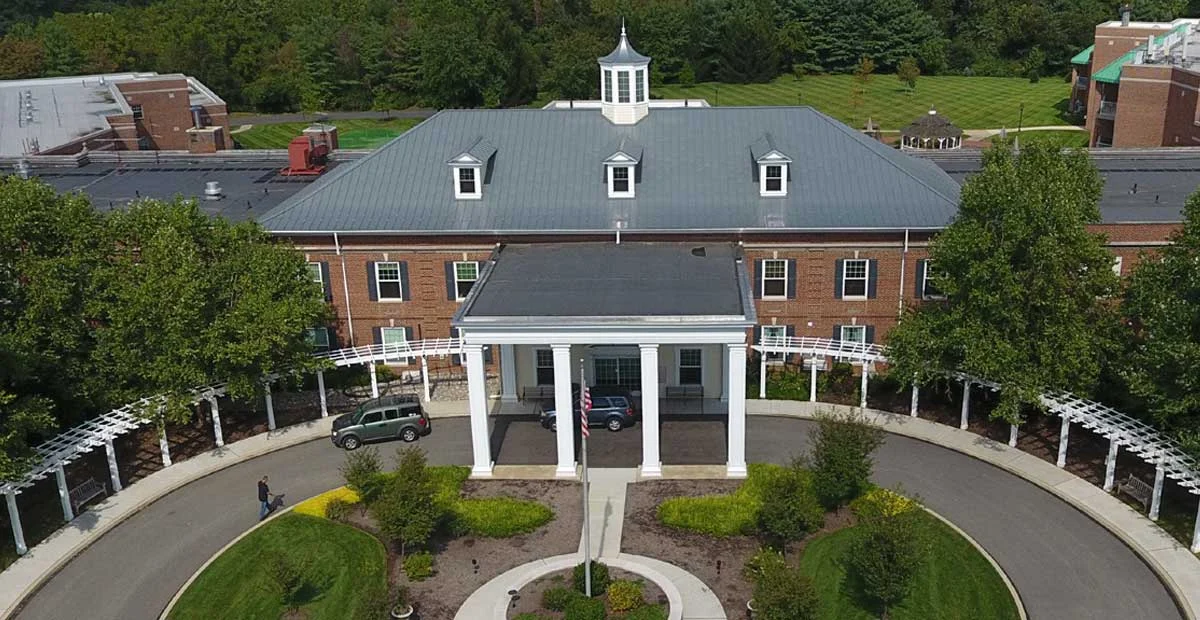 Aerial view of Masonic Village at Lafayette Hill, a large brick building with circular driveway.