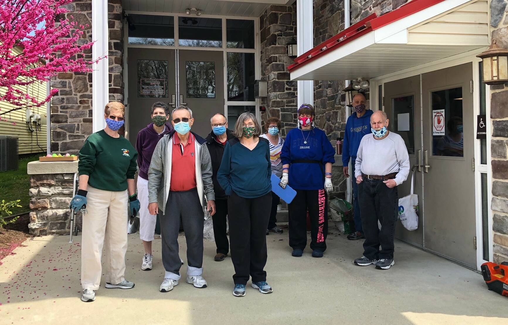 Residents of the Bleiler Caring Cottage plant flowers at Cornerstone Youth Center