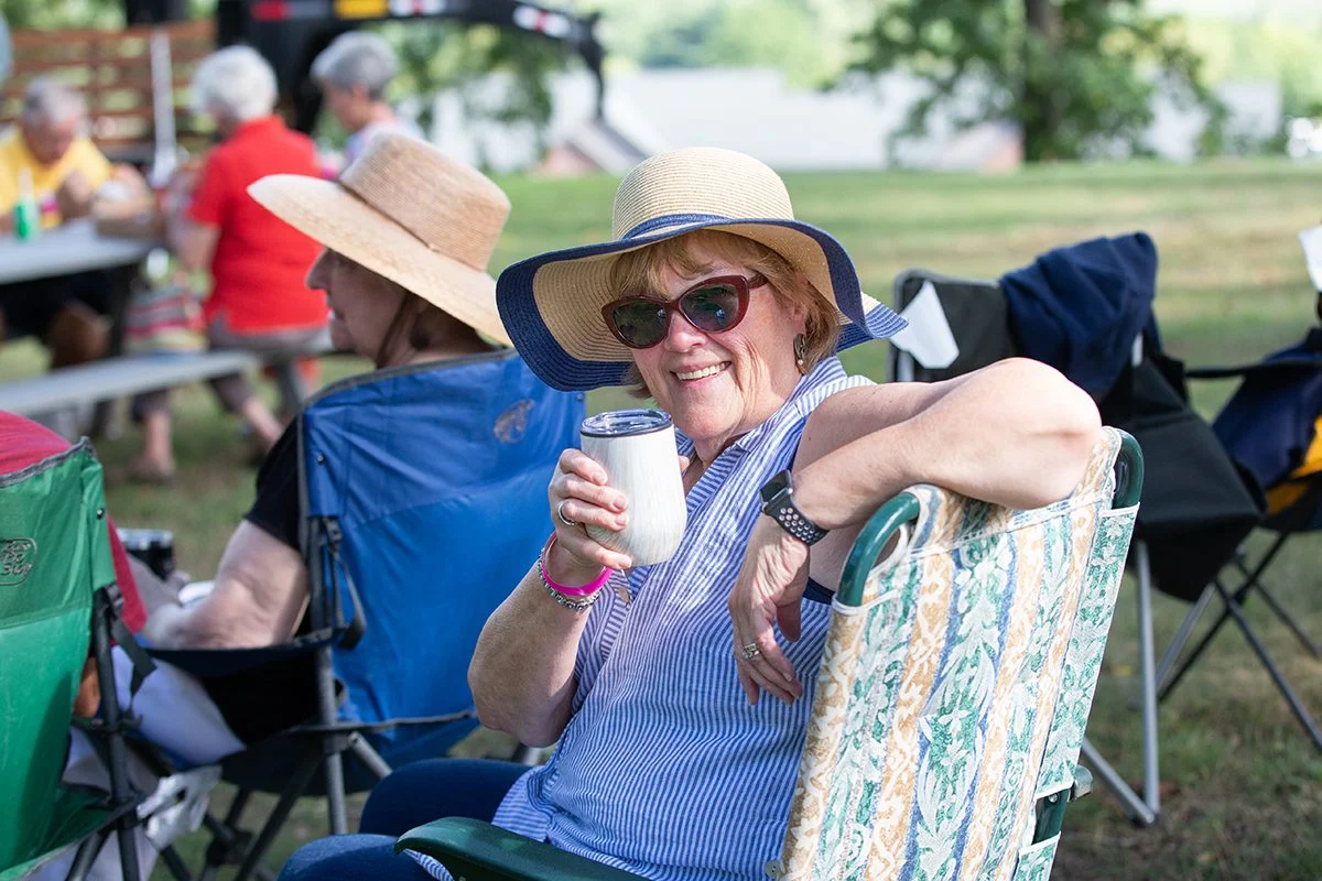 858A2900 Smiling resident at summer concert outdoors.