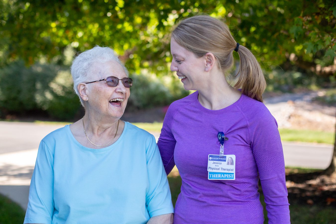 Resident walking with staff