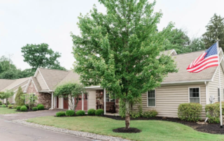 Villa with driveway and American flag in Masonic Village at Dallas.