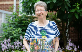 smiling woman holding assembled puzzle