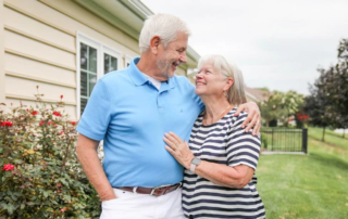 couple smiling at each other outside of home