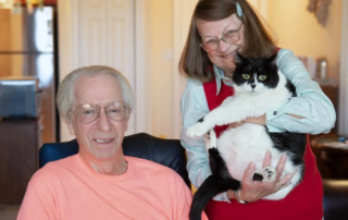 Smiling couple with their cat
