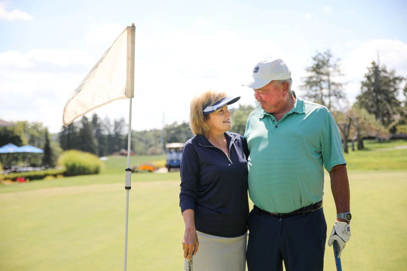 2V9A6798 Happy couple standing outdoors on golf course