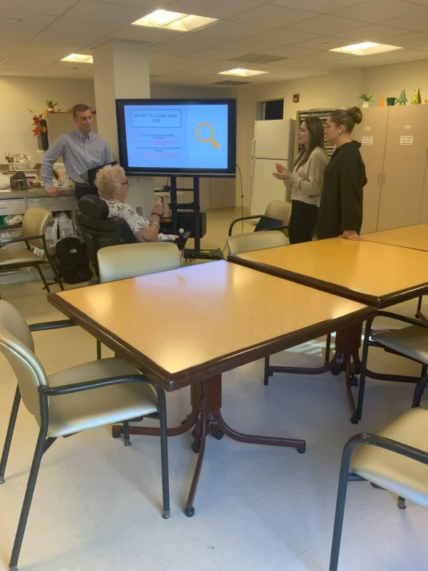 Group surrounding a tv screen.