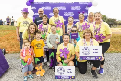 Smiling group of adults and children at Alzheimer's walk.