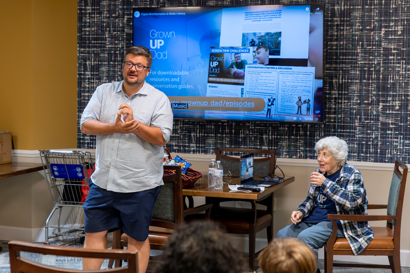 9I4A6491-Enhanced-NR Man and his mother presenting with documentary behind them