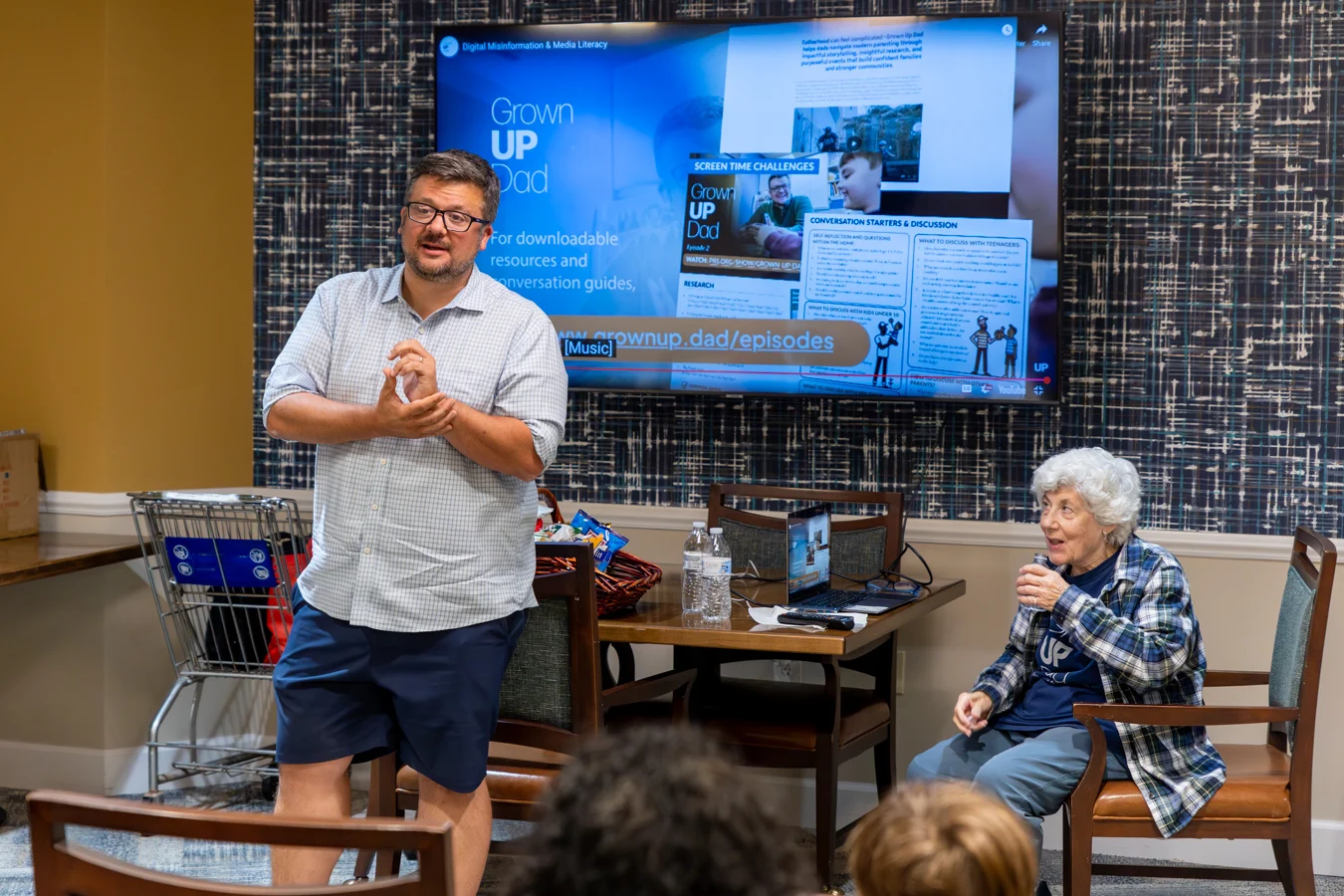 Man and his mother presenting with documentary behind them