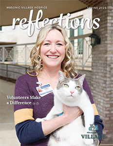 Reflections cover featuring smiling volunteer woman holding a cat.