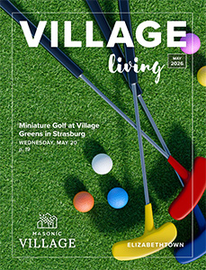 Elizabethtown Village Living Magazine cover featuring mini golf clubs and balls laying in grass.