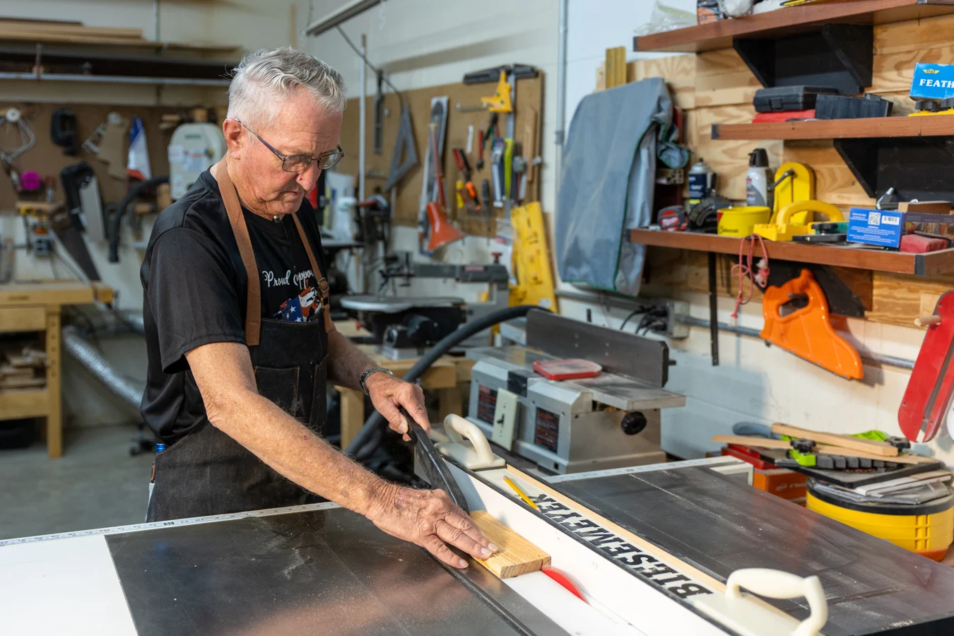 9I4A6286-1 Senior man working on a project in a woodshop.
