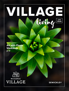 Sewickley Village Living magazine cover, featuring a close up of a green plant on a black background.